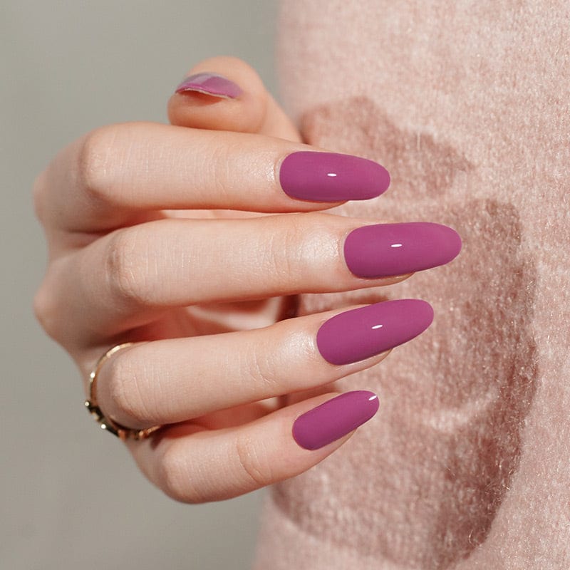 Glossy berry purple gel nail wraps showing oval shaped at-home manicure