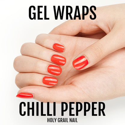 Red gel nail wraps applied to hand showing glossy vibrant manicure finish