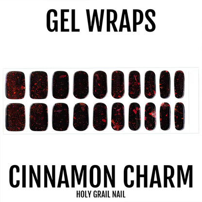 Dark gel nail wraps with red glitter accents displayed in rows showing nail art designs