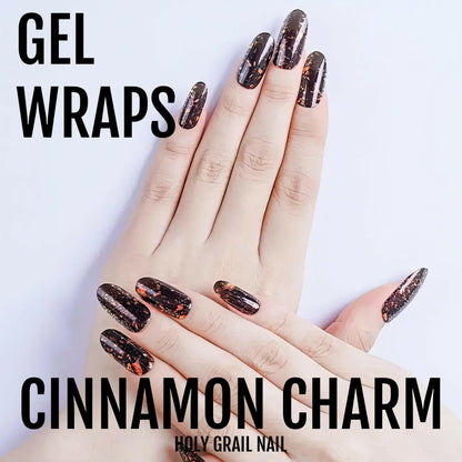 Dark burgundy gel nail wraps with holographic glitter shown on hand