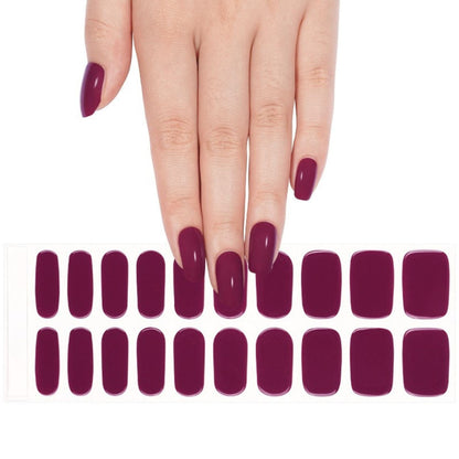 Deep burgundy gel nail wraps on hand with matching nail wraps sheet for at-home manicure