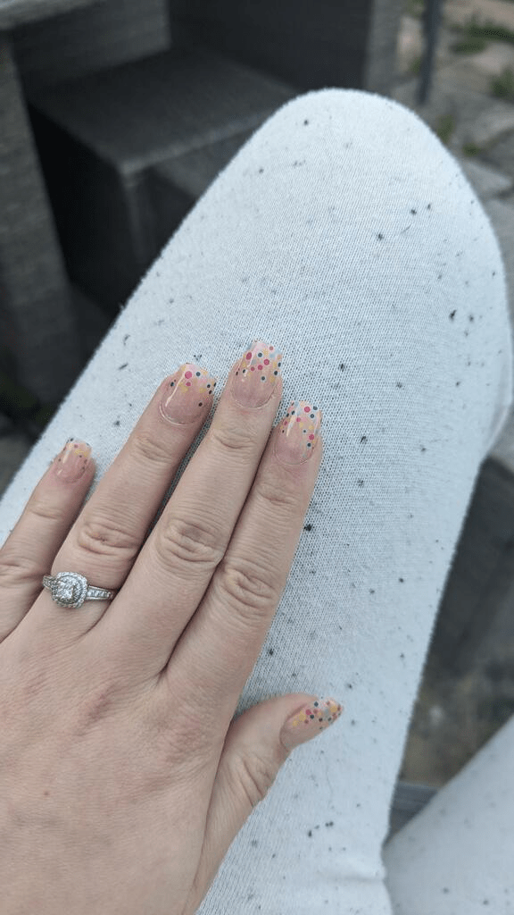Pink gel nail wraps with colourful confetti dots on hand, bubblegum semi-cured manicure