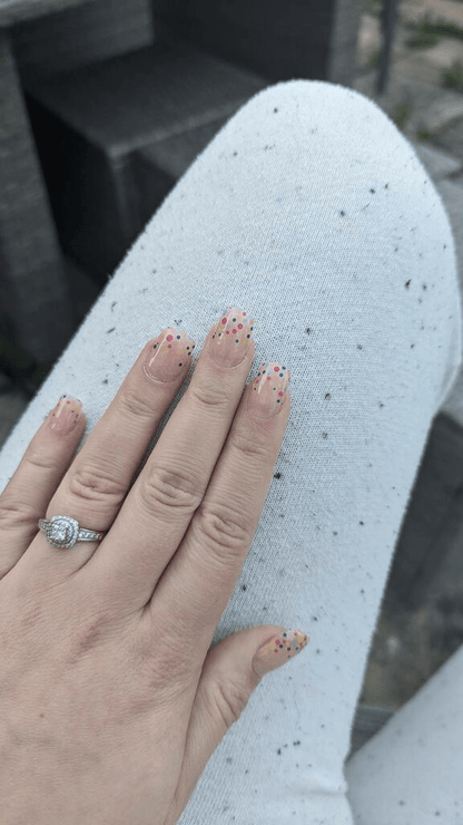 Pink gel nail wraps with colourful confetti dots on hand, bubblegum semi-cured manicure