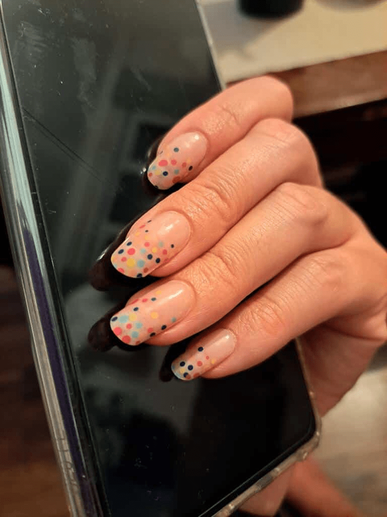 Confetti pattern gel nail wraps in pink with multicoloured dots on hand