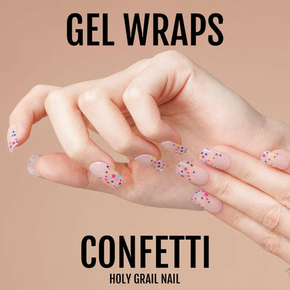 Pink confetti gel nail wraps with colourful dots on hand showing at-home manicure
