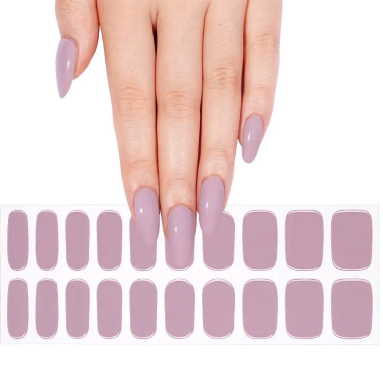 Dusty mauve gel nail wraps displayed with hand showing glossy lilac nail art manicure