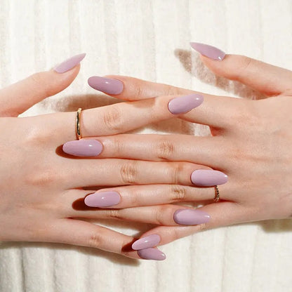Dusty pink gel nail wraps on clasped hands showing clean minimalist manicure design