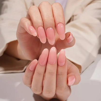 Hands showing dusty rose pink glossy gel nail wraps in sophisticated nude manicure