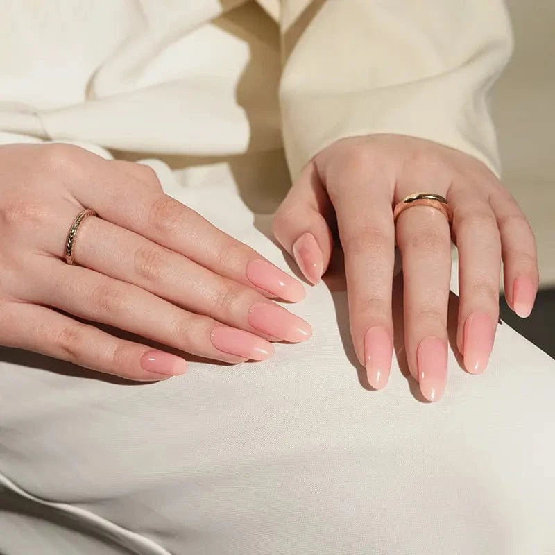 Both hands displaying dusty rose gel nail wraps with sophisticated glossy finish