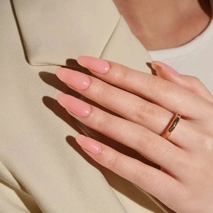 Nude pink gel nail wraps on hand showing natural glossy manicure look