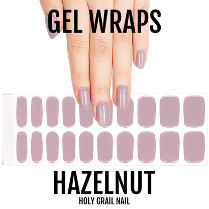 Hand showing hazelnut gel nail wraps with full sheet of neutral mauve wraps