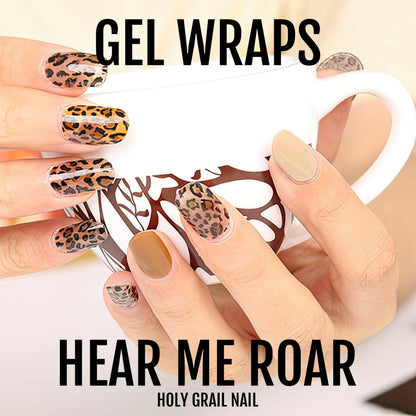 Leopard print gel nail wraps on hand showing brown and burnt orange animal print designs