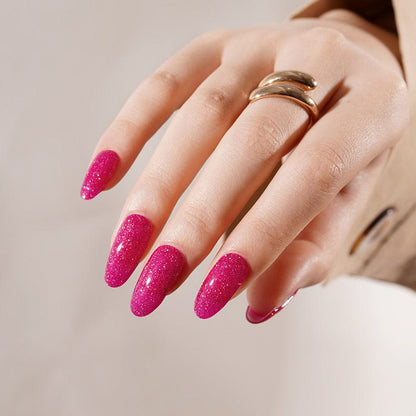 Hot pink glitter gel nail wraps on hand with sparkly finish for glamorous at-home manicure