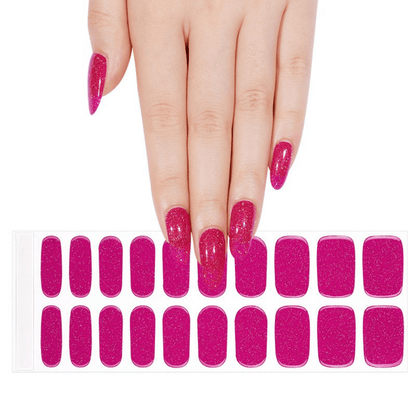 Hand displaying hot pink glitter gel nail wraps with full nail art sheet below