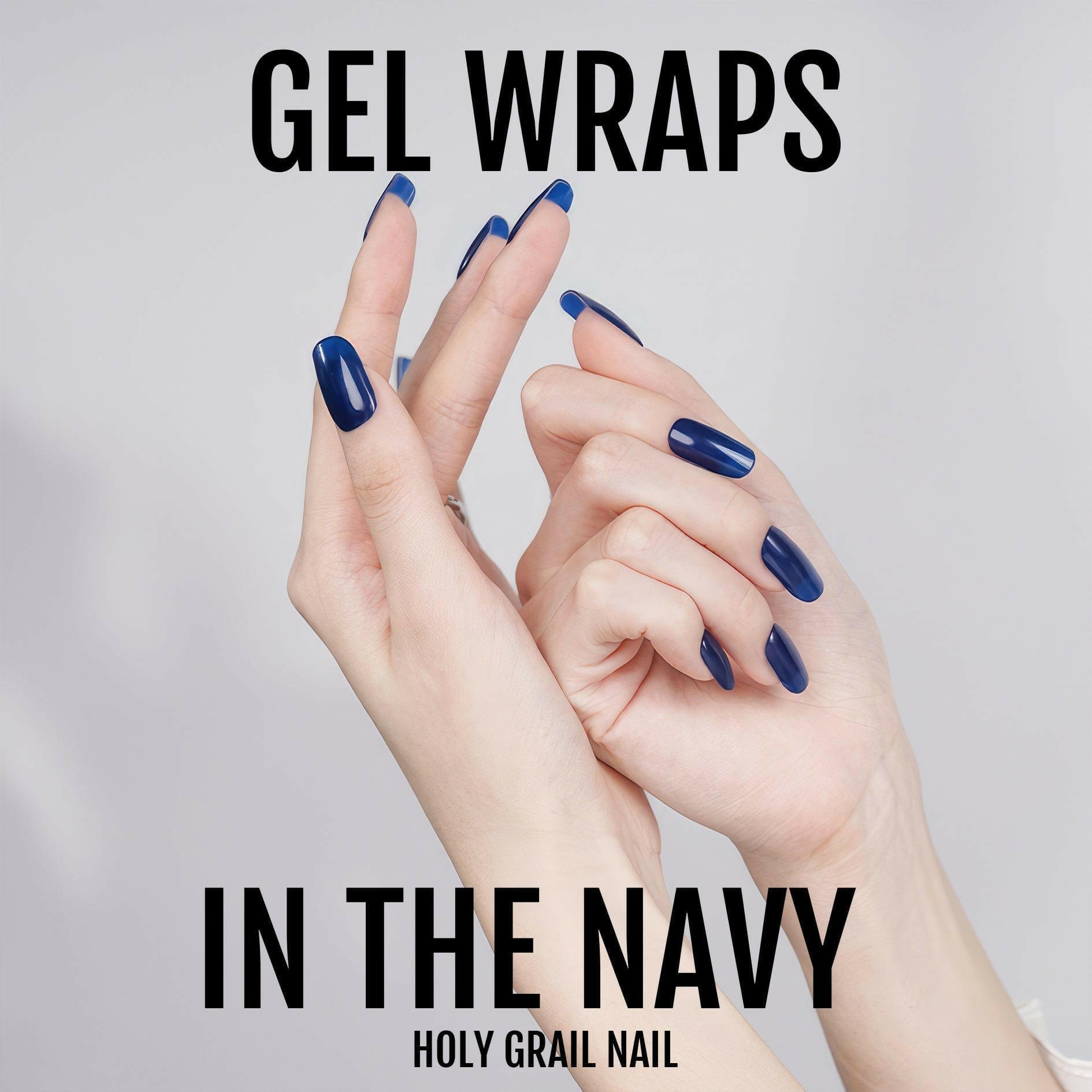 Dark blue gel nail wraps on both hands showing professional manicure finish