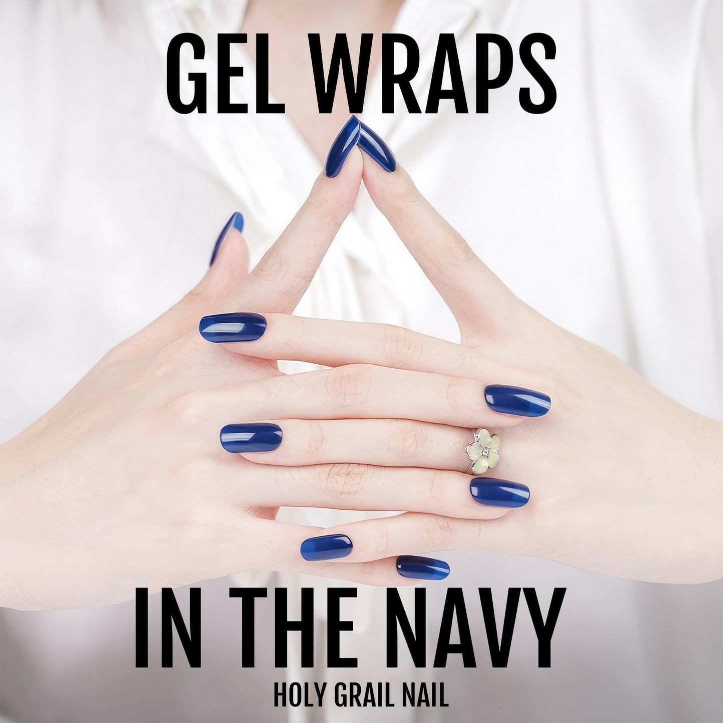 Navy gel nail wraps on interlaced hands displaying elegant glossy blue nails