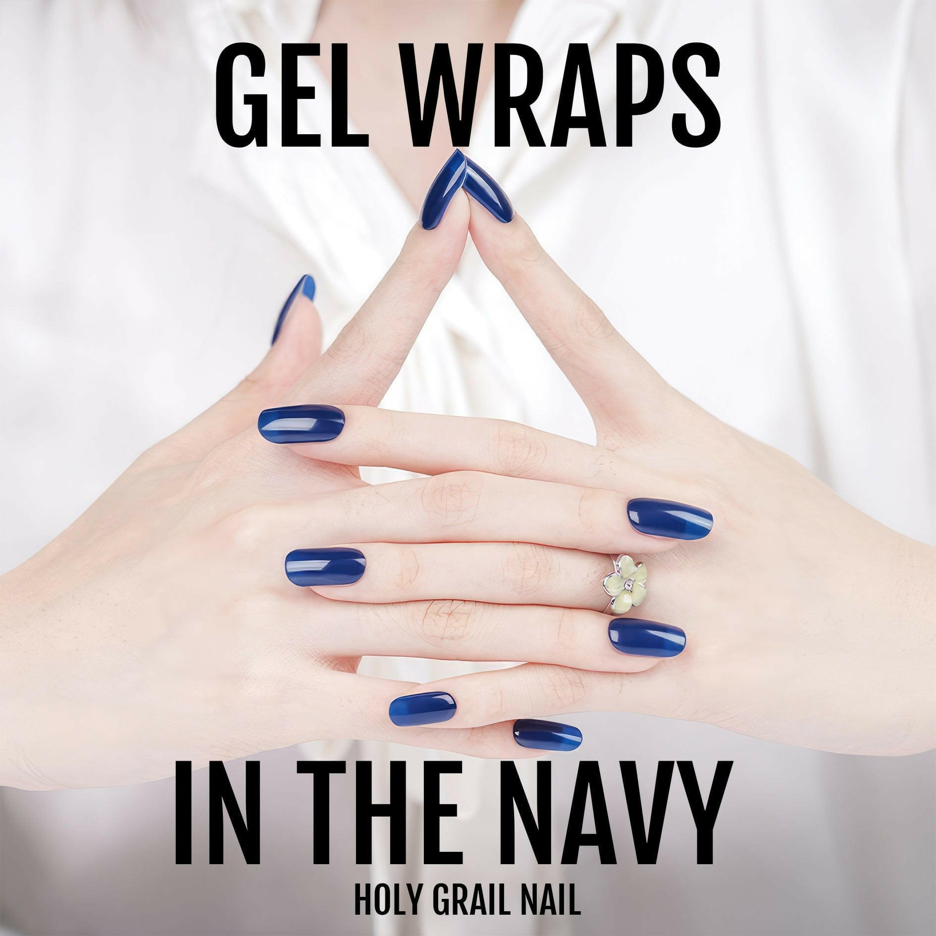 Navy gel nail wraps on interlaced hands displaying elegant glossy blue nails
