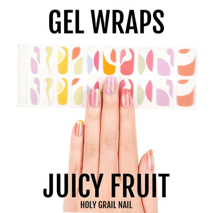 Translucent gel nail wraps in pastel rainbow abstract fruit pattern displayed on hand
