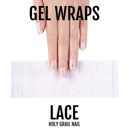 Hand displaying delicate white lace pattern gel nail wraps with intricate feminine design