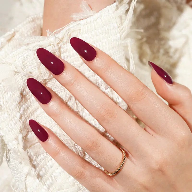 Malbec burgundy gel nails on hand with elegant deep red glossy finish