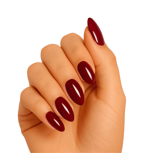 Deep burgundy gel nail wraps on hand showing glossy wine red manicure