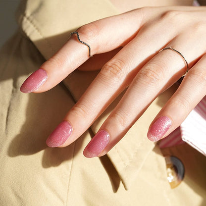 Mauve sparkle gel nails on hands with micro glitter finish for professional nail art