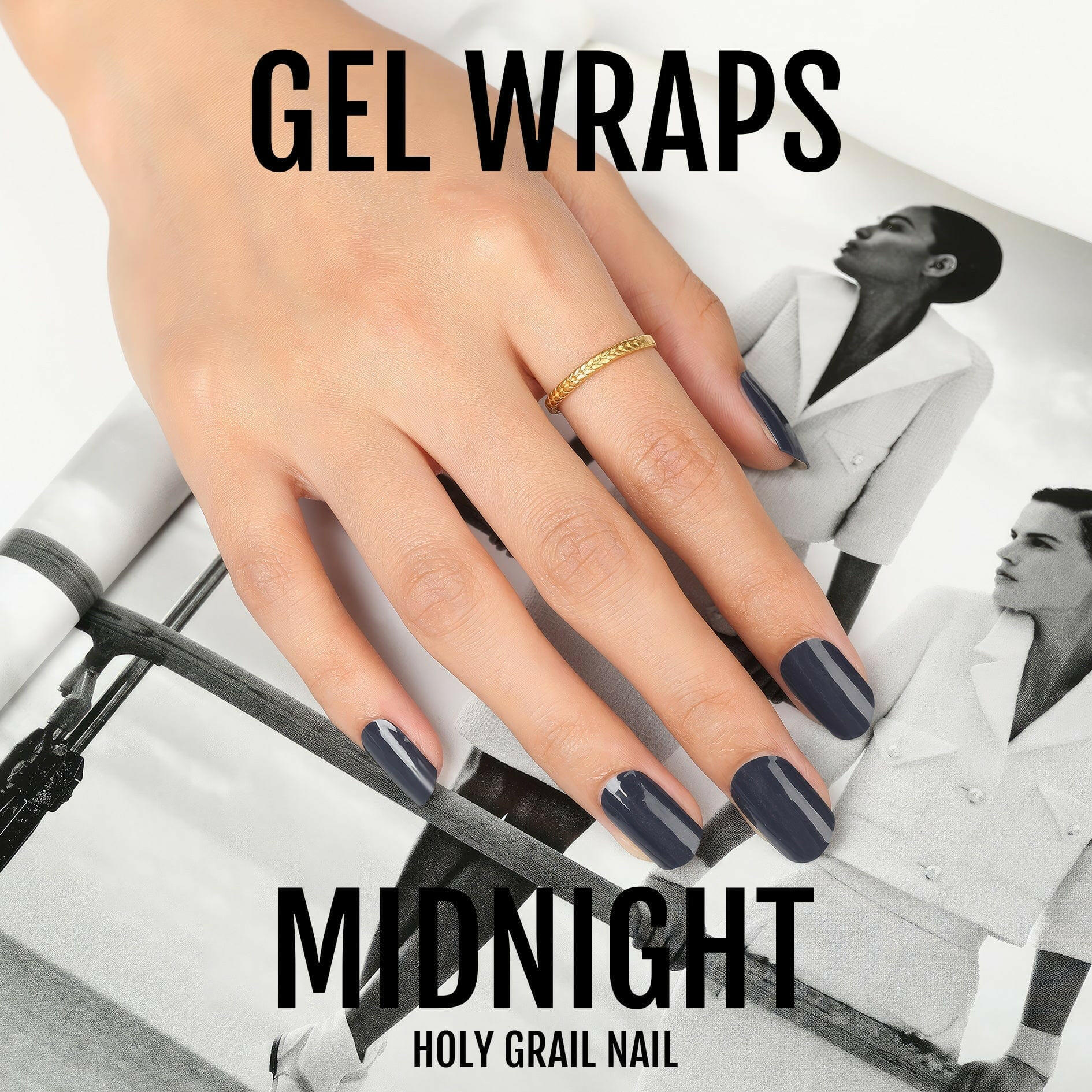 Hand with black gel nail wraps holding magazine displaying midnight dark nail art design