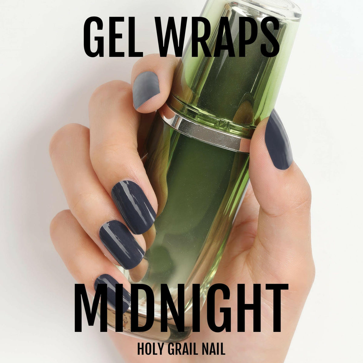 Black glossy gel nail wraps on hand holding green nail polish bottle for manicure