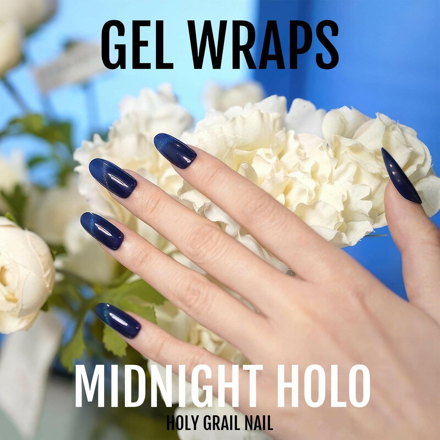Midnight holographic gel nail wraps on hand with white flowers showing dark blue finish
