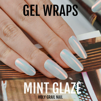 Mint glazed gel nail wraps with iridescent finish on manicured hand
