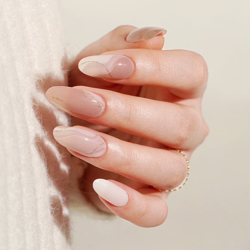 Close-up hand displaying glossy nude pink gel nails with pearl marble finish