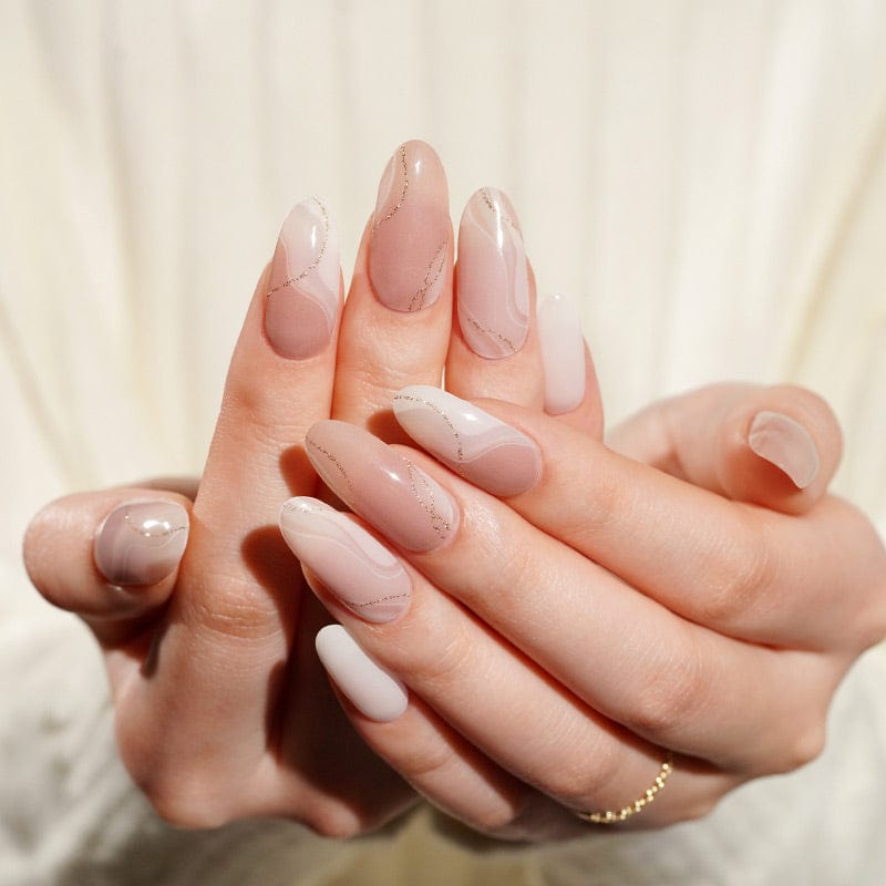 Cupped hands showing nude gel nail wraps with champagne marble shimmer effect