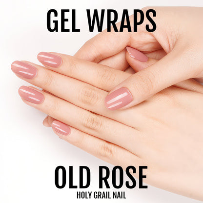 Hands with dusty pink gel nail wraps in old rose shade for elegant at-home manicure