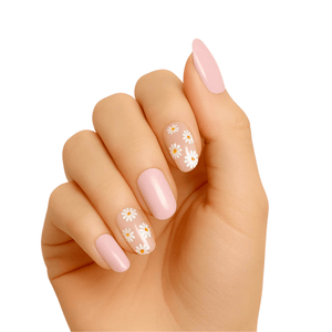 Pink gel nail wraps with white daisy flowers on hand showing floral nail art design