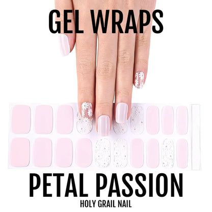 Hand showing pink gel nail wraps with white daisy patterns and nail wrap sheet