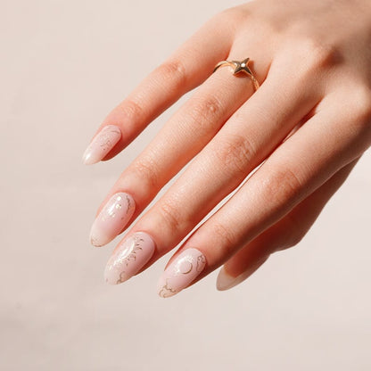 Rose gold cosmic nail art gel wraps with spiritual symbols on elegant hand