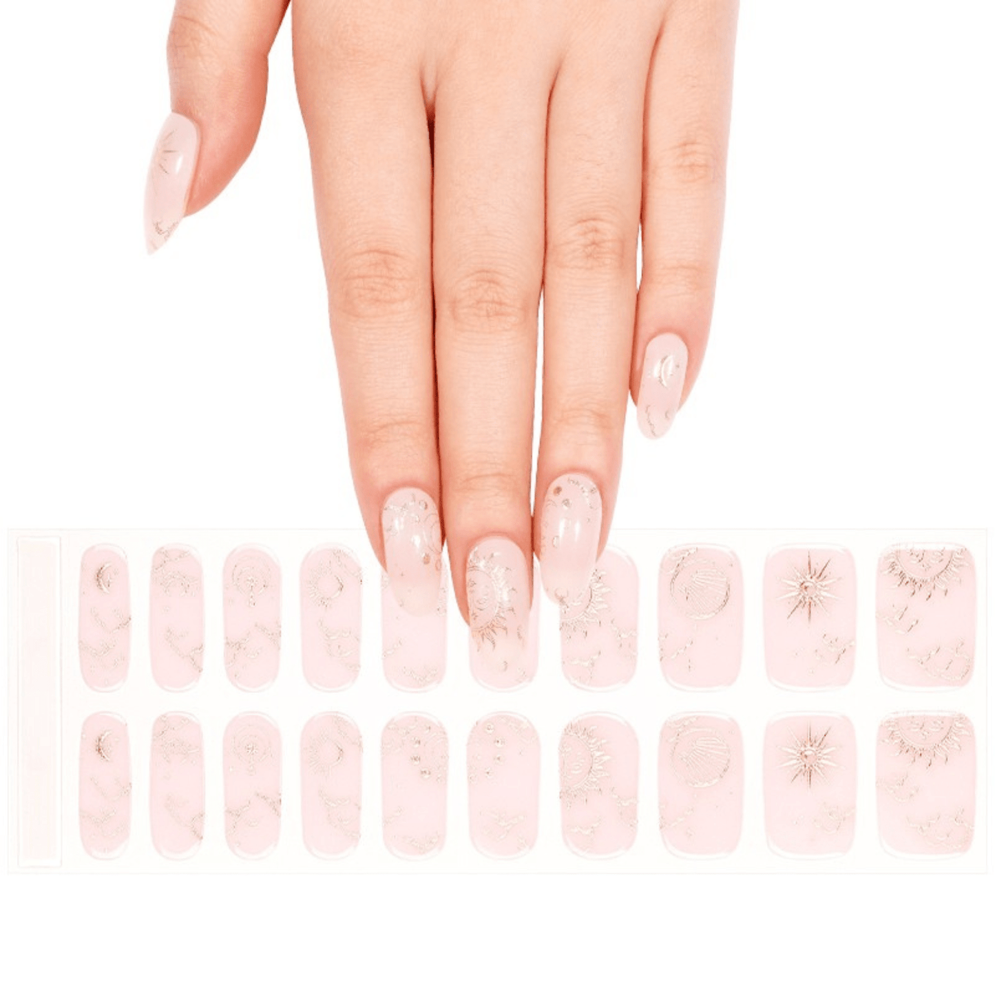 Hand wearing pink nude gel nail wraps featuring rose gold celestial fortune tarot designs