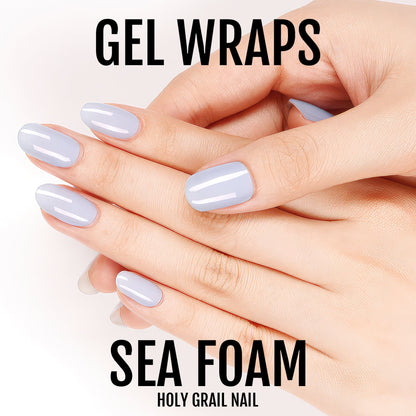 Light blue gel nail wraps on hand showing powder blue manicure finish