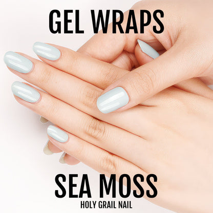 Pale blue gel nail wraps on hands showing glossy pastel manicure finish