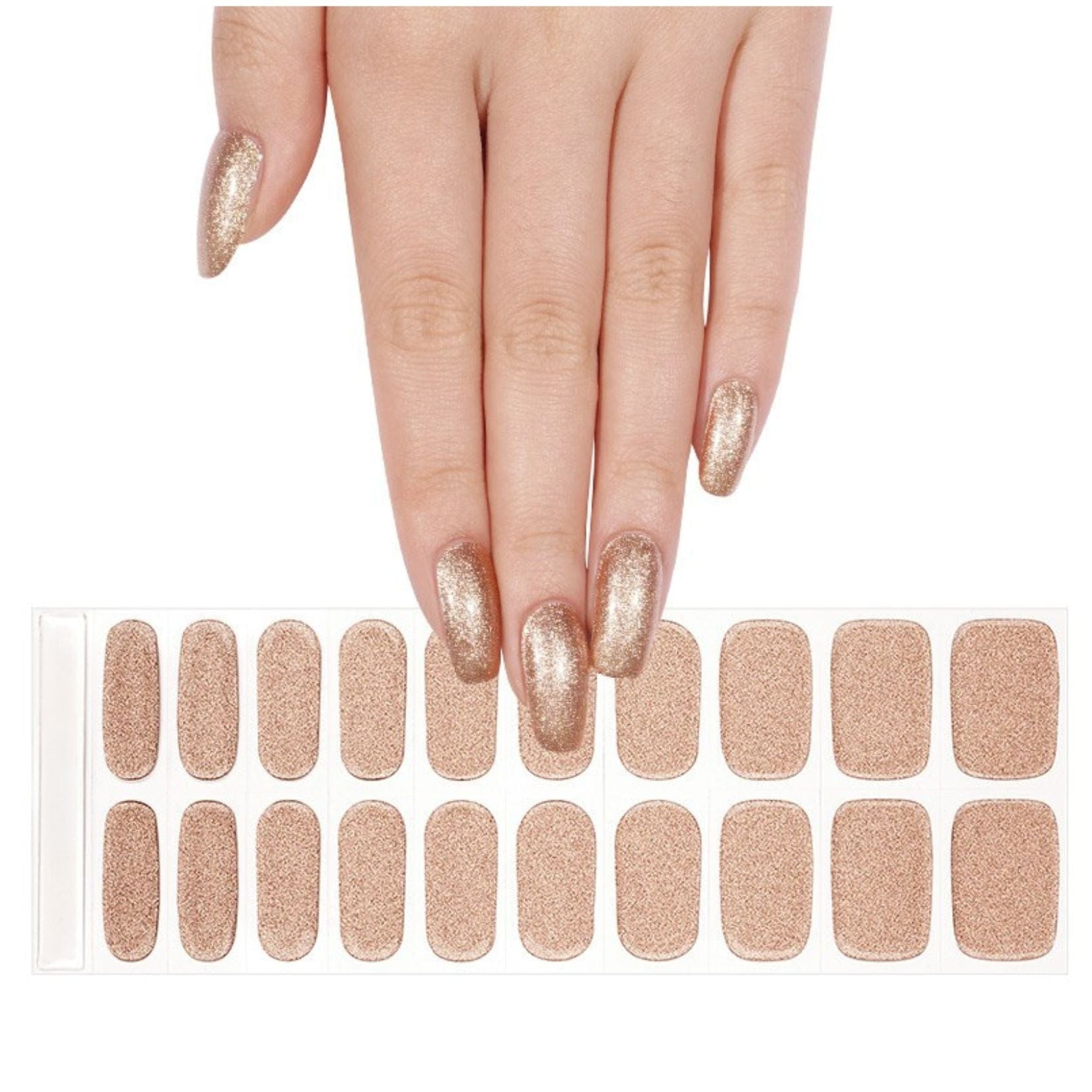 Hand wearing champagne gold glitter gel nail wraps next to full sheet of nail wraps