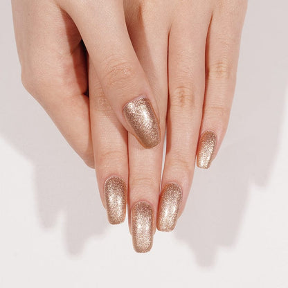Bronze gold shimmer gel nail wraps on hand showing metallic glitter finish manicure