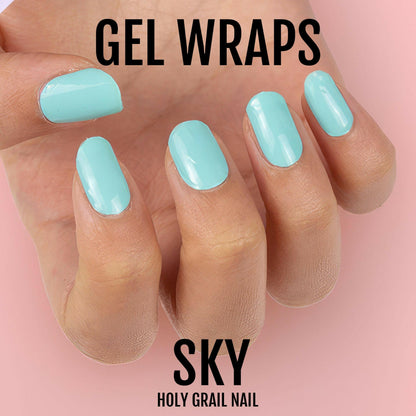 Glossy turquoise gel nail wraps on hand against pink background for nail art design