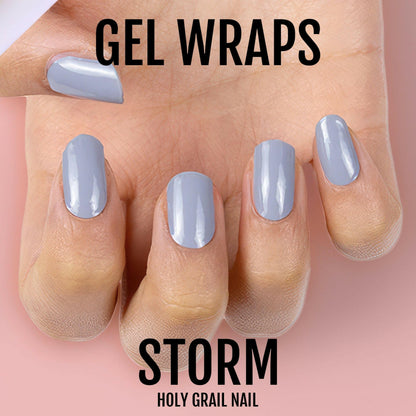 Glossy grey gel nail wraps on hand showing smooth professional manicure finish
