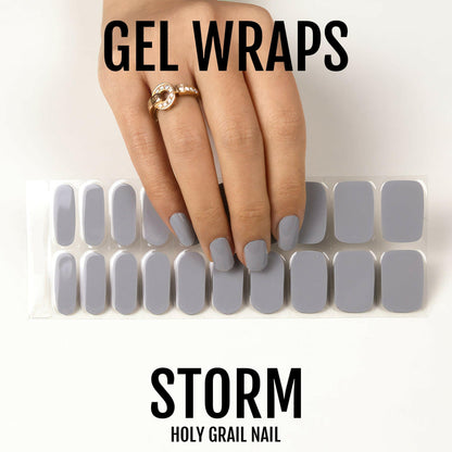 Storm grey gel nail wrap sheet with hand displaying finished glossy manicure