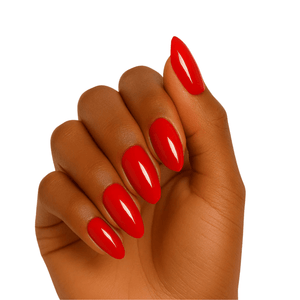 Glossy red gel nail wraps on hand showing bright crimson manicure finish