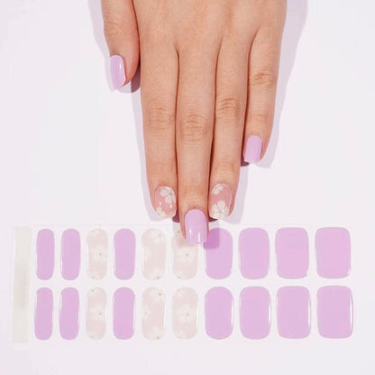 Pastel purple gel nail wraps with delicate white flower designs for feminine manicure