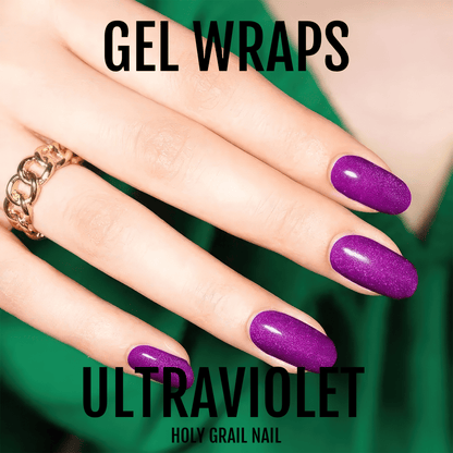 Hand with gold bracelet wearing purple metallic gel wraps nail art