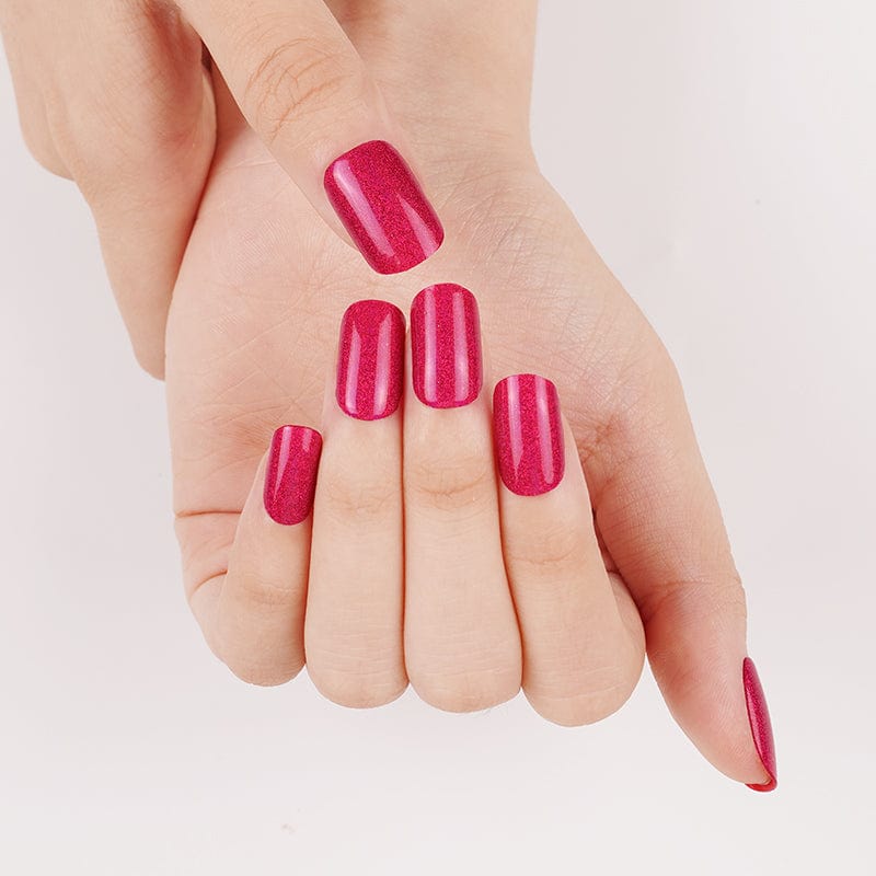 Magenta pink sparkly gel nail wraps displayed on open palm hand