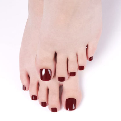 Deep wine burgundy gel pedicure wraps on feet showing glossy finish for at-home pedicure