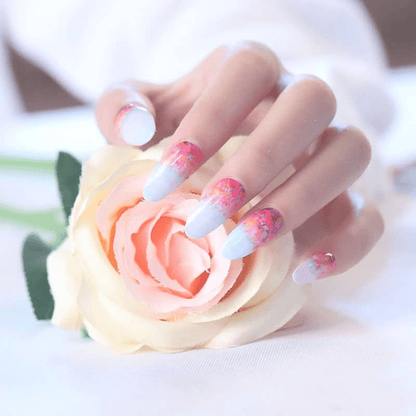 Hand wearing blue and coral ombre nail wraps with watercolour floral design